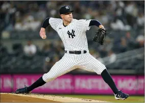  ?? JOHN MINCHILLO - THE ASSOCIATED PRESS ?? FILE - New York Yankees starting pitcher Corey Kluber throws during the first inning of the team’s baseball game against the Cleveland Indians, Friday, Sept. 17, 2021, in New York.