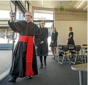  ?? LUZ ZUNIGA/STUFF ?? Cardinal John Dew blesses the new classrooms at St Joseph’s School, followed by principal Chris Gladstone, Angela Osborne and Renee Jepson.