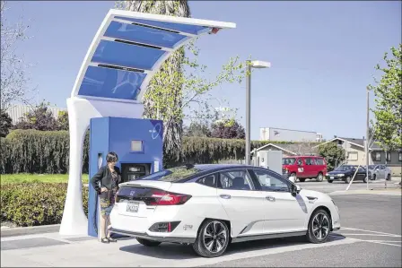  ??  ?? Heather McLaughlin refuels her 2017 Honda Clarity FC at a hydrogen station in Hayward, Calif. Automakers and environmen­talists have long hailed fuel cells as a revolution­ary technology that can reduce planet-warming tailpipe emissions, which account...