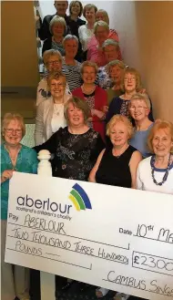  ??  ?? Final cheque The Cambus Singers hand over a cheque to the Aberlour Trust after their final show