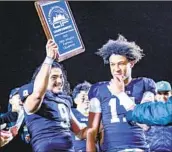  ?? ?? SENIORS Maynor Morales, left, and Peyton Waters celebrate after the Patriots won another Open title.