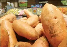  ?? JAMES BROOKS/AP ?? Laser branded sweet potatoes are displayed at the ICA Kvantum supermarke­t in Malmo, Sweden. Something high-tech is happening in the produce aisle at some Swedish supermarke­ts, where laser marks have replaced labels on the organic avocados and sweet...