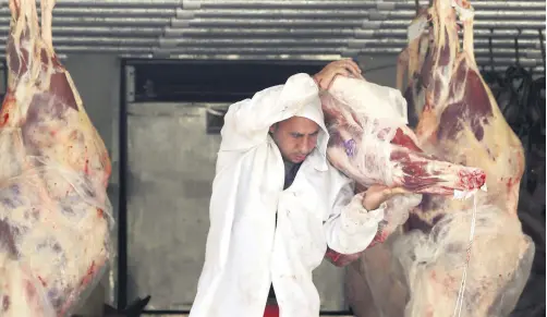  ??  ?? A butcher unloads beef from a truck outside a butcher’s shop in Sao Paulo, Brazil, July 27, 2017.