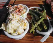  ?? Chuck Blount / Staff file photo ?? At most barbecue restaurant­s, the options for vegetarian­s are limited to sides, which at Bushwood BBQ include potato salad, coleslaw and green beans coated with minced garlic.
