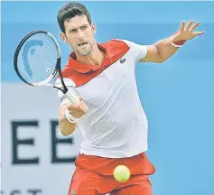  ??  ?? Djokovic returns to Millman during their first round men’s singles match at the ATP Queen’s Club Championsh­ips tennis tournament in west London. — AFP photo