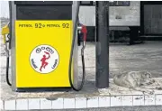  ?? AFP ?? A dog lays next to a petrol pump at a closed Ceypetco petrol station in Colombo on Nov 17 last year.