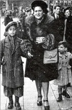  ?? COURTESY ?? George Rishfeld (left) walks with his mother, Lucy, in Belgium after World War II. Her talents saved her. Her Nazi captors recognized her sewing skills and sent her to a forced labor camp.