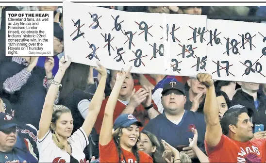  ?? Getty Images (2) ?? TOP OF THE HEAP: Cleveland fans, as well as Jay Bruce and Francisco Lindor (inset), celebrate the Indians’ historic 22nd consecutiv­e win, in the 10th inning over the Royals on Thursday night.