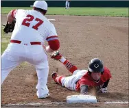  ?? RICK PECK/SPECIAL TO MCDONALD COUNTY PRESS ?? McDonald County’s Oakley Roessler dives back to first after reaching on an infield hit in the Mustangs’ 2-1 loss to Webb City on April 4 at Webb City High School.