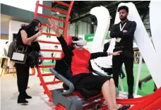  ?? ?? A visitor experience­s the Ferrari World virtual reality roller coaster at the Arabian Travel Market in Dubai