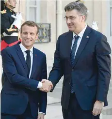  ?? — AFP ?? French President Emmanuel Macron (L) welcomes Prime Minister of Croatia Andrej Plenkovic at the Elysee Palace in Paris on Tuesday.