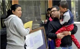  ?? — G. N. JHA ?? Parents with their child stand besides a notice board at a school in New Delhi on Wednesday, the first day of the nursery admissions.