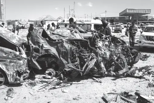  ?? AFP PHOTO ?? THE WRECKAGE of a car that was destroyed during the car bomb attack is seen in Mogadishu. A massive car bomb exploded in a busy area of Mogadishu leaving at least 76 people dead, many of them university students.