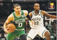  ?? Morry Gash / Associated Press ?? The Celtics’ Jayson Tatum tries to drive past the Bucks’ Khris Middleton during the second half of Game 5 of a second-round playoff series on Wednesday in Milwaukee.