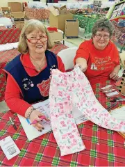  ??  ?? Salvation Army Women’s Auxiliary members Coleen, left, and Kathy display pajamas bought for a 4-year-old girl by a donor who pulled the child’s wish list from a mall Angel Tree.