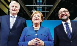  ??  ?? Acting German Chancellor Angela Merkel (centre), leader of the Christian Social Union in Bavaria (CSU) Horst Seehofer (left) and Social Democratic Party (SPD) leader Martin Schulz yesterday