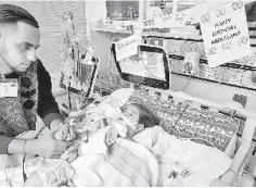  ?? — AFP photo ?? File photo courtesy of the Council on American-Islamic relations in Sacramento shows the young Abdullah Hassan on life support at UCSF Benioff Children’s Hospital in Oakland, California with his father, Ali.