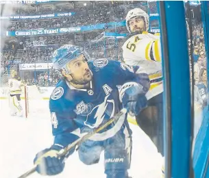  ?? DIRK SHADD/TRIBUNE NEWS SERVICE ?? Lightning winger Ryan Callaha jostles with Bruins defenceman Adam McQuaid in the corner in Monday night’s Game 2 in Tampa. The Bruins host the next two games of the series.