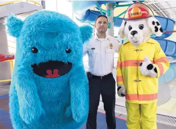  ?? RICK NATHANSON/JOURNAL ?? Fire Chief Paul Dow is flanked by “Leroyo,” left, the mascot for the Ditch and Water Safety Task Force, and “Sparky,” the fire prevention mascot for Albuquerqu­e Fire Rescue.