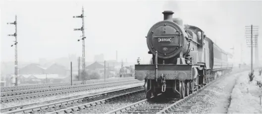 ?? Author ?? Taking the 1879 Dalry Junction to Haymarket West Junction spur in the opposite direction is Fowler three-cylinder ‘4P’ Compound No 40938 on the 11.40am Edinburgh (Princes Street) to Stirling service. This view dates from June 1955 and records the 4-4-0 running in alongside the E&G main line before joining it at Haymarket West, a glimpse of Haymarket engine shed on the left assisting with placing the location – the running along the E&G will continue through to Polmont, where it will join the Stirlingsh­ire Midland Junction line. Built at Derby Works as the penultimat­e member of its fleet – 45 Midland Railway engines and 195 new to the LMS – the pictured locomotive entered service in September 1932 and is proudly sporting a 63B (Stirling) shedcode, so is heading home. In BR days it stayed true to Caledonian main line sheds, apt for the so-called ‘True Line’, serving from Perth South, Stirling, and Forfar, its final workings coming on return to Perth South shed in February-June 1956.