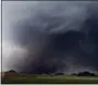  ?? ALONZO ADAMS - THE ASSOCIATED PRESS ?? In this Monday, May 20, 2013 file photo, a tornado moves past homes in Moore, Okla. Emergency officials in Oklahoma, Texas and Kansas are bracing for the start of what’s historical­ly the most active time of year for tornadoes while also facing wildfire...