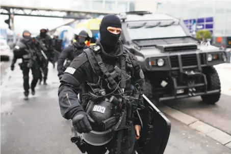  ?? Benjamin Cremel / AFP / Getty Images ?? Officers secure Paris’ Orly Airport after French security forces fatally shot a man believed to have been an Islamic extremist.