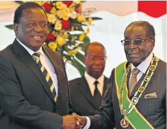  ?? Picture: Reuters ?? Emmerson Mnangagwa, left, now president of Zimbabwe, shakes hands with Mugabe at an event in Harare three years ago.