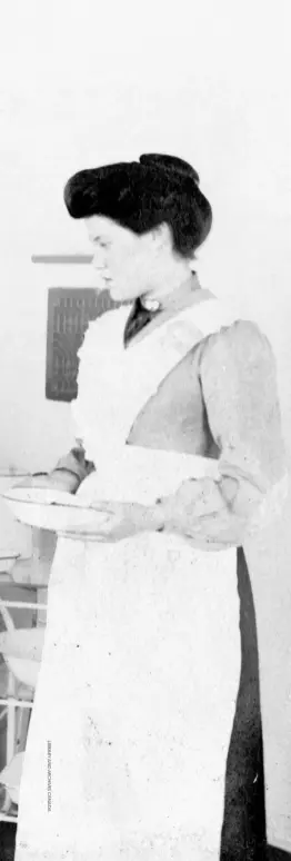  ??  ?? A nurse stands by as Dr. Wilfred Grenfell examines a young patient being held by a woman, possibly also a nurse, at Harrington Harbour, Quebec, circa 1905 to 1915.