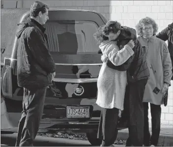  ?? AP PHOTO ?? Mourners embrace after the hearse carrying the casket of Jerry Rabinowitz, one of 11 people killed while worshippin­g at the Tree of Life Synagogue last Saturday, arrives outside the Jewish Community Center in Pittsburgh, Tuesday.