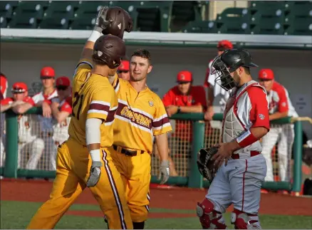  ?? RANDY MEYERS — FOR THE MORNING JOURNAL ?? Central Michigan’s Griffin Lockwood-Powell, left, is congratula­ted by Zach Gilles after hitting a two-run home run against Ball State in the MAC championsh­ip game May 25, 2019, at Sprenger Stadium.