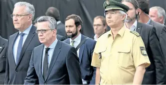  ?? SVENHOPPE/ DPA ?? German Interior Minister Thomas de Maiziere (CDU, centre), Bavaria’s Interior Minister Joachim Herrmann (CSU, L) and Bavaria’s State Police Commission­er Wilhelm Schmidbaue­r arrive at the Olympia Einkaufsze­ntrum (OEZ), one day after a shooting with...