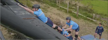  ??  ?? The Mahoneys climbing one of the final obstacles, watched on by Wexford hurler Lee Chin.