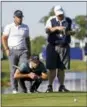  ?? GERALD HERBERT — THE ASSOCIATED PRESS ?? Kevin Kisner lines up a putt as teammate Scott Brown stands behind him on the 18th green during a sudden-death playoff for the PGA Zurich Classic golf tournament’s new twoman team format at TPC Louisiana in Avondale, La., Monday. The pair finished...