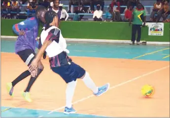  ??  ?? Job Caesar (right) of Bent Street completing a pass while under pressure from Jamal Codrington (left) of Campbellvi­lle at the National Gymnasium in the Xtreme Clean/GT Beer Futsal Championsh­ips Saturday night