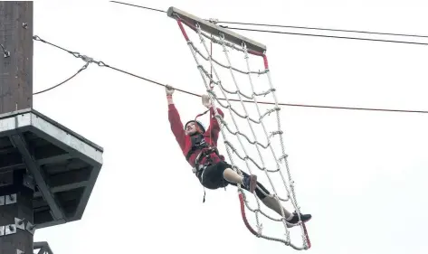  ?? JULIE JOCSAK/POSTMEDIA NEWS ?? Samantha Martin, 14, of Niagara Falls, makes her way through an aerial obstacle course at the new WildPlay in Niagara Falls. WildPlay's Whirlpool Adventure Course was officially opened on Friday.