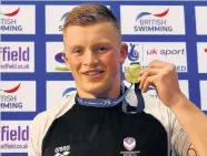  ??  ?? Gold medalist Adam Peaty of Loughboro poses with the medal won in the Mens Open 100m Breaststro­ke final. Photo by Dan Mullan/Getty Images.