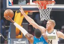  ?? Matthew Stockman, Getty Images ?? Nuggets forward Mason Plumlee, defending against Paul George of the Oklahoma City Thunder, intends to be “ready to play” whenever he is called to do so.