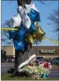  ?? THE ASSOCIATED PRESS ?? Flowers and balloons are shown Wednesday near a Walmart store where a mass shooting took place.