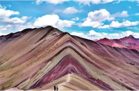  ??  ?? A multi-colored mountain in Vinicunca National Park, in the Cusco district of Peru