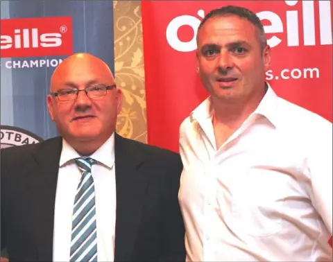  ??  ?? David Tully, Chairman of the NEFL, presents a Tully Bookmakers Cup medal to Muirhevnam­or official Sean Maguire.