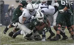  ?? AL GOLDIS - THE ASSOCIATED PRESS ?? Michigan State’s Kenneth Walker III (9) rushes for a touchdown against Penn State’s Jaquan Brisker (1) during the first quarter Saturday in East Lansing, Mich.