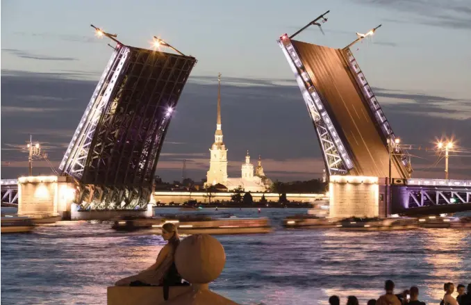  ??  ?? THE Peter and Paul fortress stands beyond the Palace Bridge, raised to allow a boat to pass through, on the River Neva in St Petersburg, Russia.
|
Bloomberg