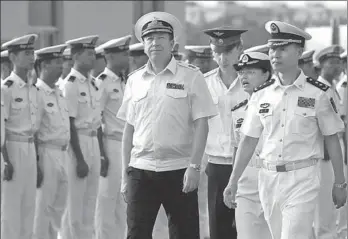  ?? LI JIN / FOR CHINA DAILY ?? Deputy Commander of the Chinese Navy Wang Hai and his Russian counterpar­t Aleksandr Fedotenkov walk on Monday to greet a group of five Russian ships arriving for eight days of joint drills in the waters off Zhanjiang, Guangdong province. The two navies expect to further improve their abilities for joint operations with these fifth annual exercises.