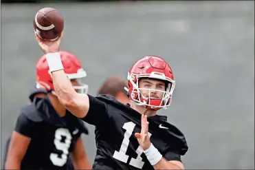  ??  ?? Georgia quarterbac­k Jake Fromm throws a pass during the team’s first scheduled NCAA college football practice in Athens. Georgia fully expects to contend for a national championsh­ip. Now, the Bulldogs have to show they can finish the job after coming tantalizin­gly close the last two seasons.