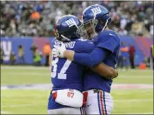  ?? BILL KOSTROUN — THE ASSOCIATED PRESS ?? Giants wide receiver Sterling Shepard, left, and quarterbac­k Eli Manning celebrate after they connected for a long touchdown pass during Sunday’s loss to Eagles.