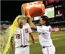  ?? AP PHOTO ?? QUENCHING THIRST FOR VICTORY: Matt Wieters gets doused by teammate Anthony Rendon after the Nationals rallied past the Orioles last night in Washington.