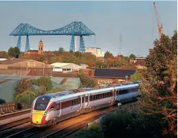  ?? LNER ?? LNER has introduced a midweek daily journey between Middlesbro­ugh and London King’s Cross. With the famous Middlesbro­ugh Transporte­r Bridge in the background, an LNER Azuma heads through the area.