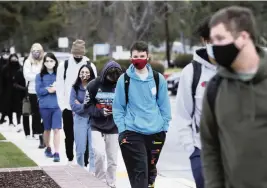  ?? AL SEIB TNS ?? Students line up for screening questions and temperatur­e check as those in grades 9-12 returned to Thousand Oaks High School for in-person learning on Monday March 8, 2021, for the first time this school year.