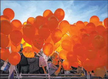  ?? Oded Balilty The Associated Press ?? Demonstrat­ors hold balloons at a rally in Tel Aviv, Israel, in solidarity with Kfir Bibas, an Israeli boy who spent his first birthday Thursday in Hamas terrorist captivity.