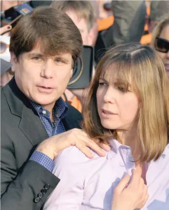  ??  ?? Former Gov. Rod Blagojevic­h stands outside his home with his wife Patti in 2012 before reporting to federal prison. Robert Blagojevic­h